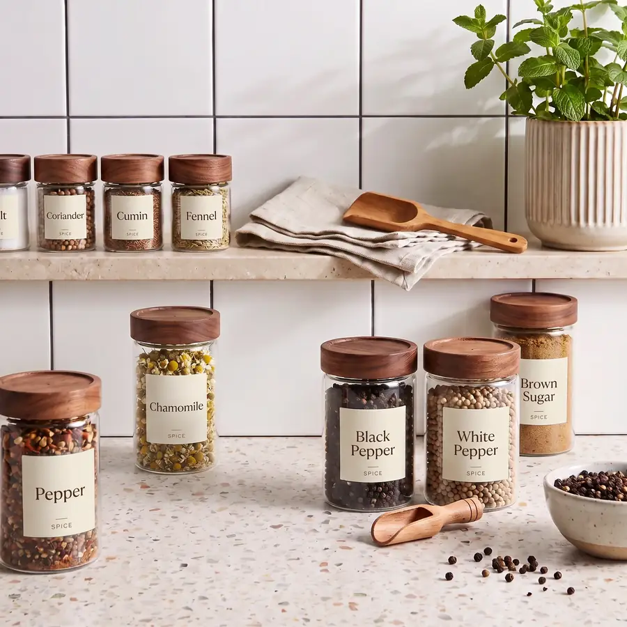 Spice jars arranged on an open kitchen shelf