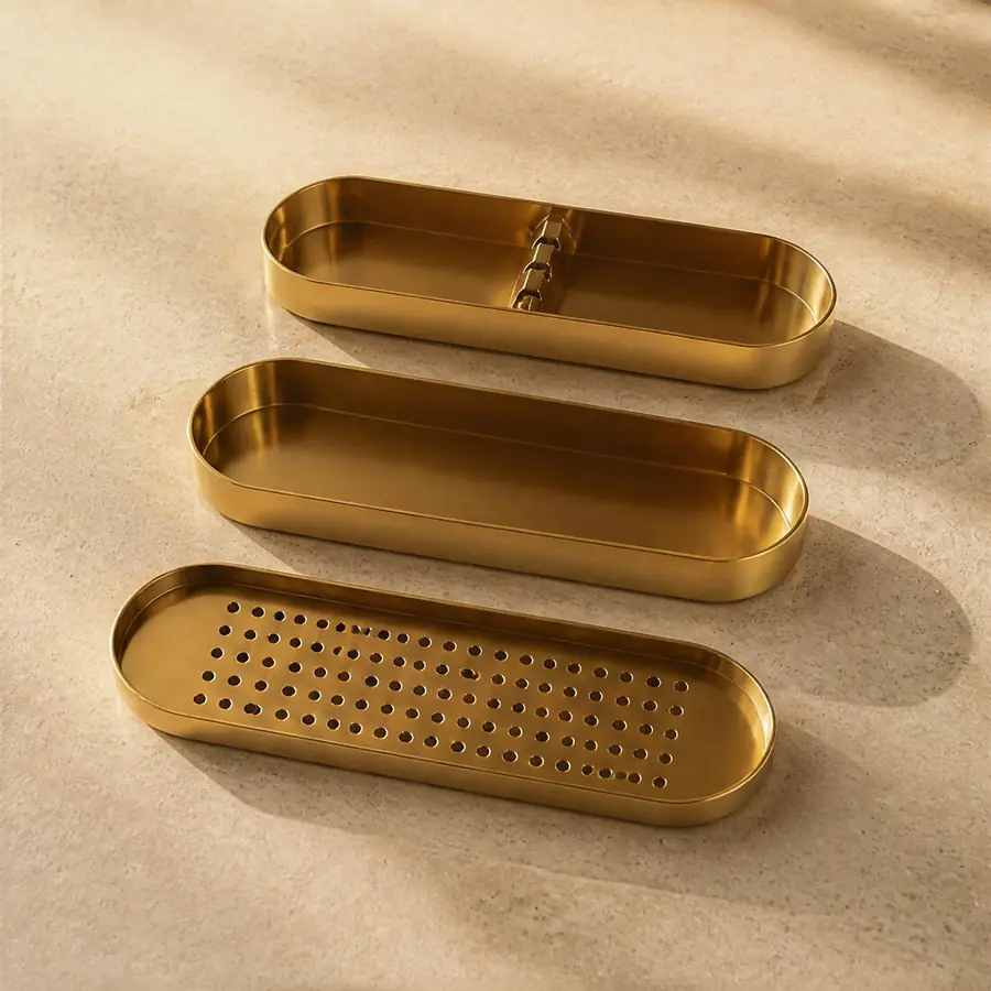 The Ember closed into one brass vessel, styled on a shelf beside a framed print